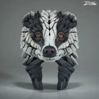 Rock sculpture of a wolf's head made from layered stones with orange eyes, standing on two stone legs.
